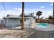 An eye-level shot of the in-ground pool with safety fence at 6121 Edgewood Cir, Las Vegas, NV 89107