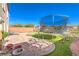 Private backyard with brick patio, trampoline, artificial turf, and space for outdoor seating at 6472 Chebec St, North Las Vegas, NV 89084
