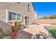 Spacious backyard featuring a brick patio, artificial turf, and a charming garden planter at 6472 Chebec St, North Las Vegas, NV 89084