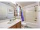Cozy bathroom with a shower-tub combo, colorful shower curtain, and a single sink vanity at 6472 Chebec St, North Las Vegas, NV 89084
