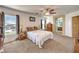 Bedroom featuring a ceiling fan, a comfortable bed, and windows that bring in natural light at 6472 Chebec St, North Las Vegas, NV 89084