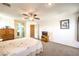 Well lit main bedroom featuring a ceiling fan and connections to a bathroom and hallway at 6472 Chebec St, North Las Vegas, NV 89084