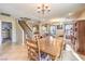 Bright dining room with tile floor, large table, and view of the staircase at 6472 Chebec St, North Las Vegas, NV 89084