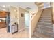 Home entryway featuring tile flooring, a staircase to the second floor, and connections to the kitchen at 6472 Chebec St, North Las Vegas, NV 89084