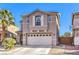 Charming home features a well-manicured yard and an attached two-car garage at 6472 Chebec St, North Las Vegas, NV 89084