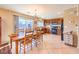 Open kitchen and dining area with tile floors and views to the backyard through sliding doors at 6472 Chebec St, North Las Vegas, NV 89084