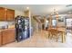 Open concept kitchen and dining area featuring tile floors and modern appliances at 6472 Chebec St, North Las Vegas, NV 89084
