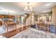 Open floor plan featuring wood flooring, large area rug, and a view of the staircase and dining area at 6472 Chebec St, North Las Vegas, NV 89084