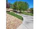 Scenic walking path surrounded by lush greenery and mature trees at 6472 Chebec St, North Las Vegas, NV 89084