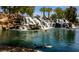 Scenic waterfall cascading into a tranquil pond, with ducks swimming below, creating a peaceful and picturesque setting at 6472 Chebec St, North Las Vegas, NV 89084