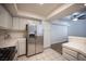 Well-lit kitchen with stainless steel refrigerator, white cabinets, and adjacent dining area at 6704 Dorita Ave # 101, Las Vegas, NV 89108