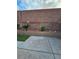 Backyard featuring a concrete patio, xeriscape landscaping, and a brick perimeter wall with accent tiles at 7317 Caballo Range Ave, Las Vegas, NV 89179