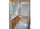 Well-lit bathroom features a shower-tub combo and vanity with a marble countertop at 7317 Caballo Range Ave, Las Vegas, NV 89179