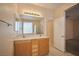 Bright bathroom featuring double sinks and a large mirror, with a shower and a separate toilet room at 7317 Caballo Range Ave, Las Vegas, NV 89179