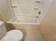 Bright bathroom with a clean, white bathtub and toilet in a well-lit interior at 7317 Caballo Range Ave, Las Vegas, NV 89179