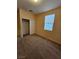 Cozy bedroom boasts plush carpeting, a window with blinds, and a convenient closet for storage at 7317 Caballo Range Ave, Las Vegas, NV 89179