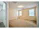 Spacious bedroom with neutral carpeting, ample natural light from two windows, and a walk-in closet at 7317 Caballo Range Ave, Las Vegas, NV 89179