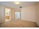 Large bedroom with neutral walls and carpet, and access to both the bathroom and hallway at 7317 Caballo Range Ave, Las Vegas, NV 89179