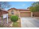 Charming single-story home with desert landscaping and a two-car garage at 7317 Caballo Range Ave, Las Vegas, NV 89179