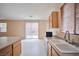Cozy kitchen with laminate flooring, a sink and white cabinets at 7317 Caballo Range Ave, Las Vegas, NV 89179