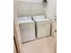 Practical laundry room equipped with a washer, dryer, and storage shelves at 7317 Caballo Range Ave, Las Vegas, NV 89179