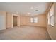 Large living room featuring carpet flooring, neutral paint and lots of light at 7317 Caballo Range Ave, Las Vegas, NV 89179