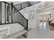 Spacious foyer boasting a staircase with black railing, grey floors and light grey walls at 770 Drewsberry Ave, Las Vegas, NV 89178