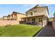 Spacious backyard with a well-maintained lawn, patio area, and privacy fence at 7717 Rosebark Cliffs St, North Las Vegas, NV 89084