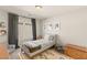 bedroom with a single bed, gray armchair, and cozy rug creating a comfortable space at 7717 Rosebark Cliffs St, North Las Vegas, NV 89084