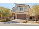 Attractive two-story home featuring a well-manicured lawn and a two-car garage at 7717 Rosebark Cliffs St, North Las Vegas, NV 89084
