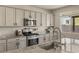 Modern kitchen featuring granite countertops, stainless steel appliances, and ample cabinet space at 7717 Rosebark Cliffs St, North Las Vegas, NV 89084