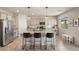 Spacious kitchen featuring a large island, stainless steel appliances, and gray cabinets at 7717 Rosebark Cliffs St, North Las Vegas, NV 89084