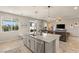 Open concept kitchen with a large island flowing into the living room area at 7717 Rosebark Cliffs St, North Las Vegas, NV 89084