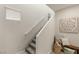 Carpeted staircase with white railing and neutral decor at 7717 Rosebark Cliffs St, North Las Vegas, NV 89084