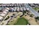 Wide aerial shot showing a community on a golf course, with single-story homes and mature landscaping at 7921 Fantail Dr, North Las Vegas, NV 89084