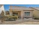 Charming backyard featuring a covered patio, landscaped gravel and desert flora at 7921 Fantail Dr, North Las Vegas, NV 89084
