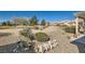 Desert landscaped backyard with rocks, cacti, small shrubs and covered patio in a desert community at 7921 Fantail Dr, North Las Vegas, NV 89084