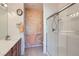 Bathroom featuring an enclosed glass shower, a single sink, and decorative walls at 7921 Fantail Dr, North Las Vegas, NV 89084