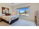 Bright bedroom featuring a comfortable bed, carpeted floors and a large window with a scenic view at 7921 Fantail Dr, North Las Vegas, NV 89084