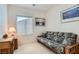 Comfortable bedroom featuring carpeted floors, a desk, and a full-size futon at 7921 Fantail Dr, North Las Vegas, NV 89084