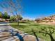 Serene common area landscape with a walking path enhances the outdoor living experience for residents at 7921 Fantail Dr, North Las Vegas, NV 89084