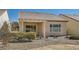 The home features a covered patio and beautiful desert landscaping at 7921 Fantail Dr, North Las Vegas, NV 89084