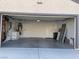Clean, empty garage with painted walls, cement floor, and visible mechanics with side door at 7921 Fantail Dr, North Las Vegas, NV 89084
