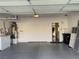 Bright garage with cement floor, water heater and utility shelf with doorway to interior of the house at 7921 Fantail Dr, North Las Vegas, NV 89084