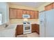 Well-lit kitchen with white appliances, tile floors, ample cabinetry, and an open view to the living area at 7921 Fantail Dr, North Las Vegas, NV 89084