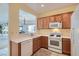 Functional kitchen with white appliances, countertops, tile flooring, and a pass-through to the living area at 7921 Fantail Dr, North Las Vegas, NV 89084