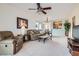 Open-concept living room and dining area with a ceiling fan, view into the kitchen, and neutral decor at 7921 Fantail Dr, North Las Vegas, NV 89084