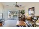 Comfortable living room boasts neutral walls, carpet, ceiling fan, and sliding door access to the patio at 7921 Fantail Dr, North Las Vegas, NV 89084