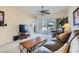 Inviting living room with sliding glass doors to the patio, ceiling fan, and comfortable furniture at 7921 Fantail Dr, North Las Vegas, NV 89084