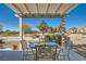 Covered patio offering scenic views of the desert landscaping. and distant mountains at 7921 Fantail Dr, North Las Vegas, NV 89084